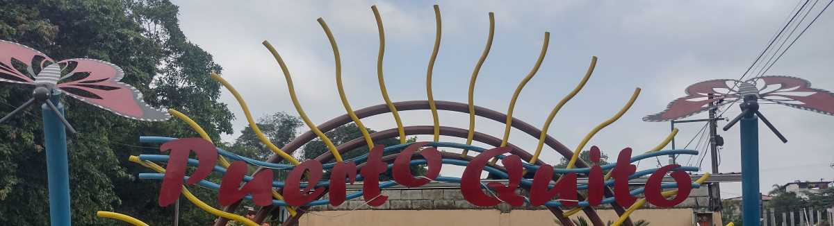 puerto-quito-sign.jpg There are two Puerto Quito city name signs. One at the town's western entrance on the highway, and this one in the riverside park.