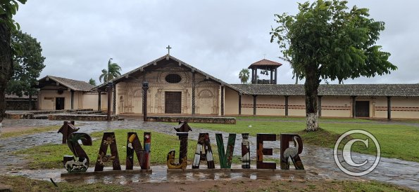 City name sign in front of Mision de San Francisco Xavier