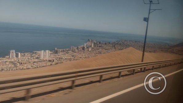 Iquique from the highway winding down the giant sand dune
