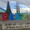 City name sign in Baeza Parque at E20 and 14 de Mayo