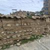 old wall around a corn field in the city