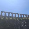arches in a wall alongside the highway